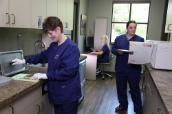 two dental assistants practicing dental infection control